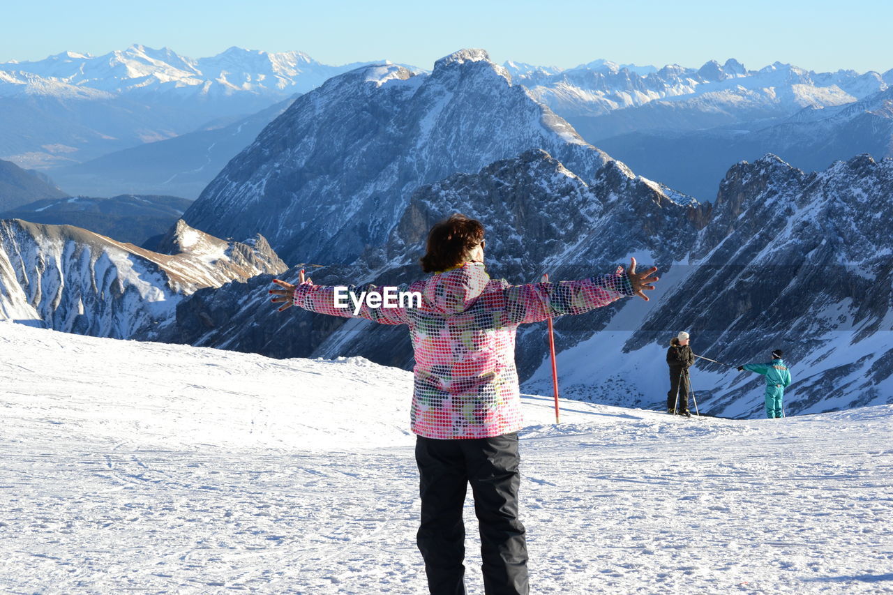 Person standing on snow covered mountain