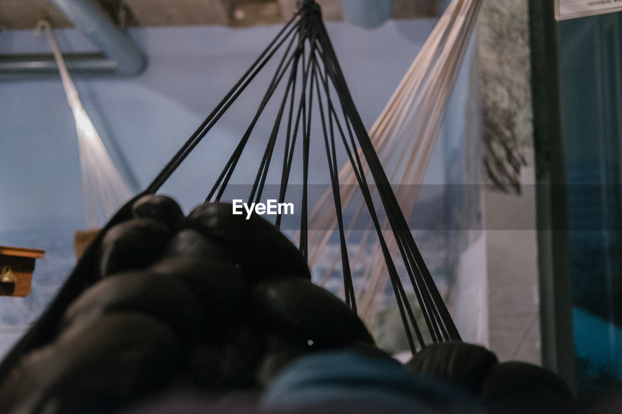 Cropped image of person relaxing on hammock at home