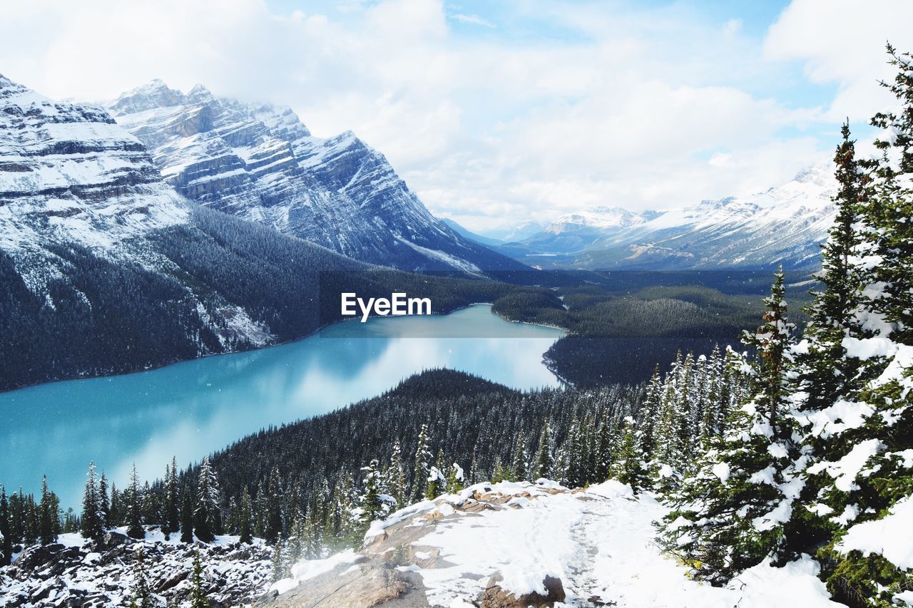 Scenic view of peyto lake against cloudy sky during winter