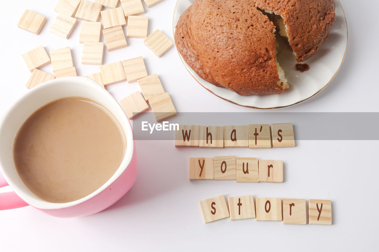 HIGH ANGLE VIEW OF COFFEE CUP AND COOKIES