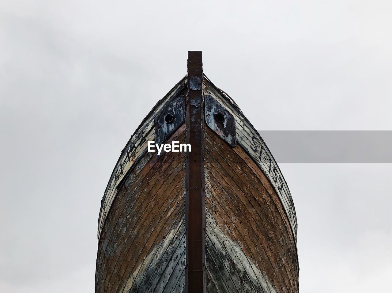 Low angle view of abandoned ship against sky