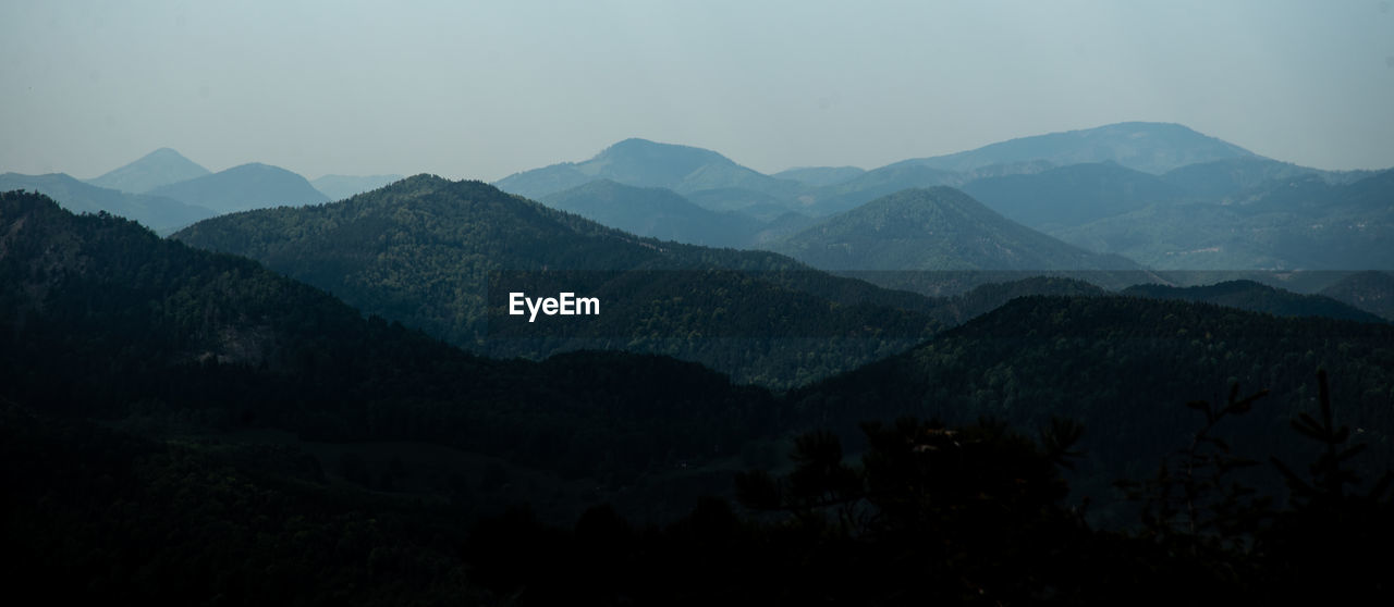 Scenic view of mountains against sky at dusk