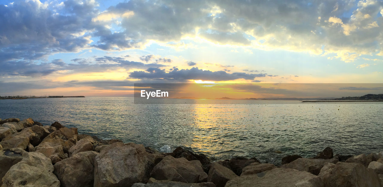 Scenic view of sea against cloudy sky