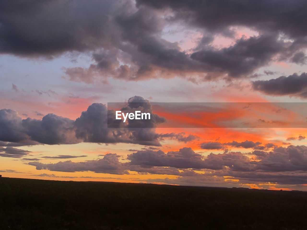 SCENIC VIEW OF DRAMATIC SKY OVER SILHOUETTE LANDSCAPE