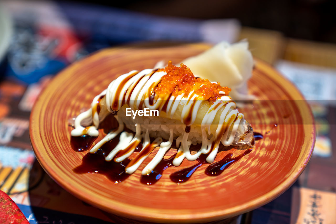 There is a delicious plate of japanese sushi on the table