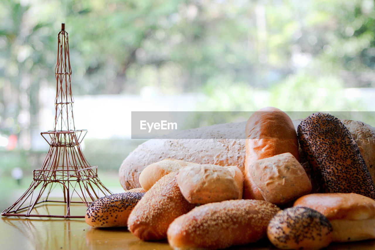 Close-up of breads with replica eiffel tower on table