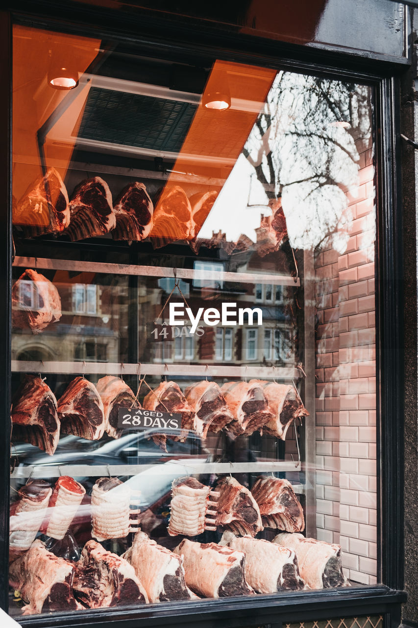 Variety of fresh raw steaks in the shopfront of hampstead butchers in hampstead, london, uk.