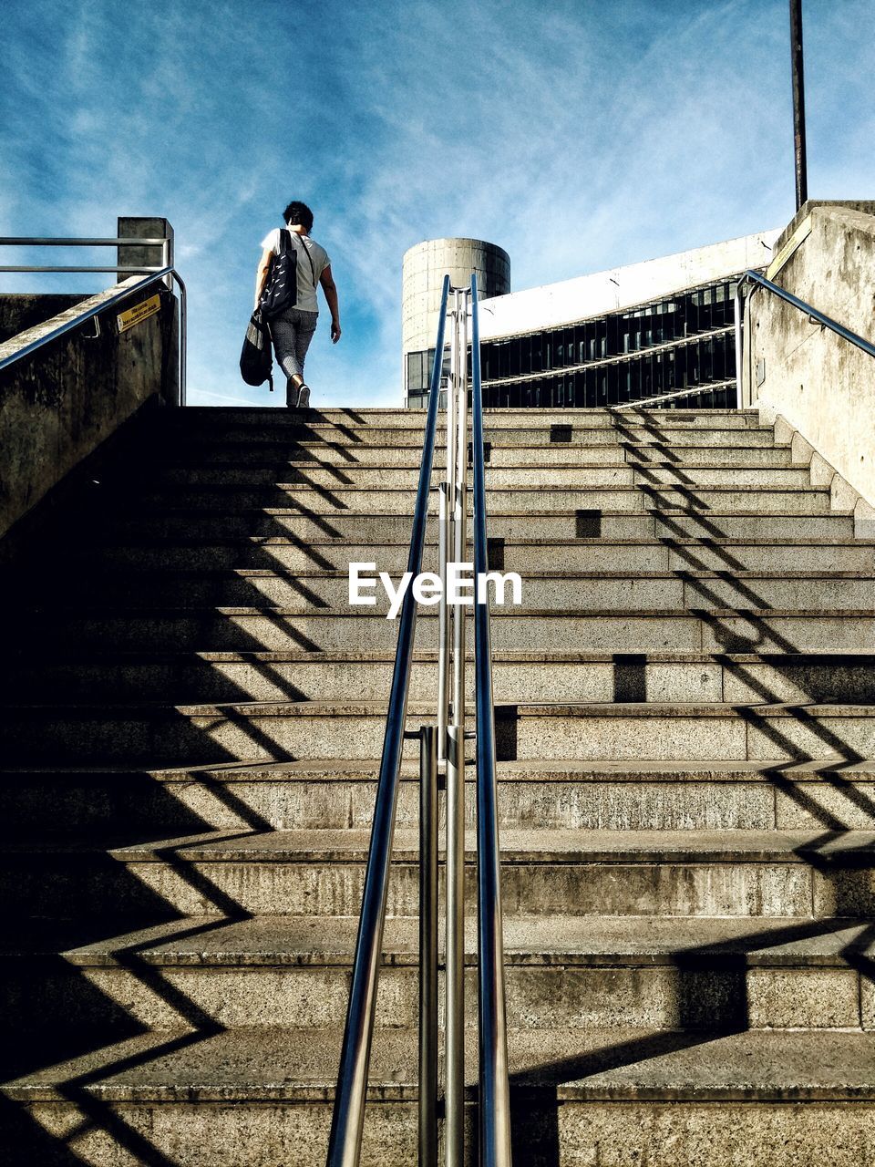 LOW ANGLE VIEW OF MAN STANDING ON STEPS