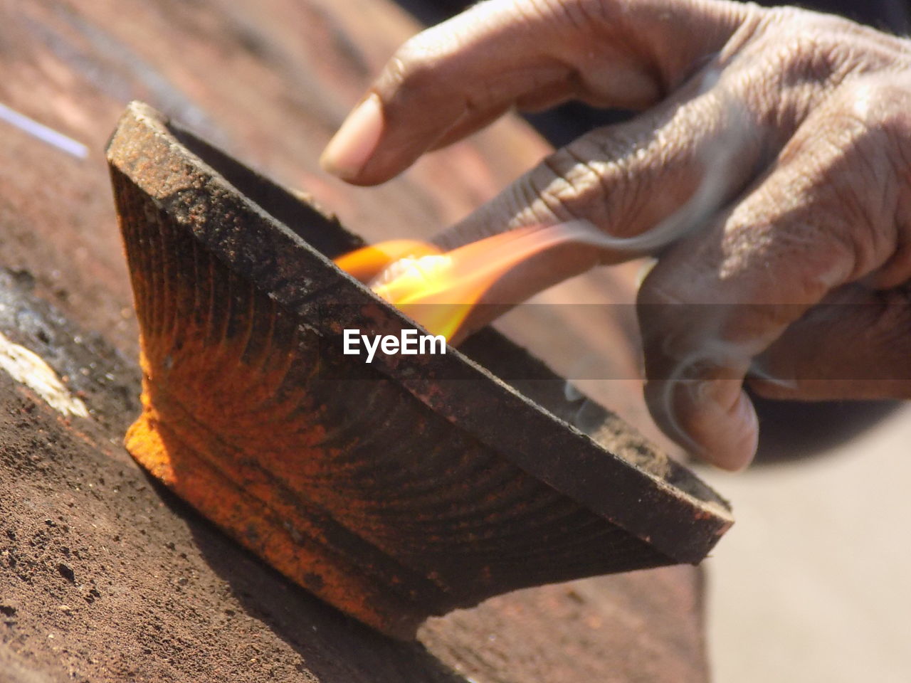 CLOSE-UP OF MAN WORKING ON WOOD