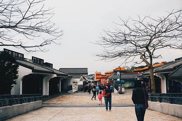 MAN WALKING ON ROAD IN CITY