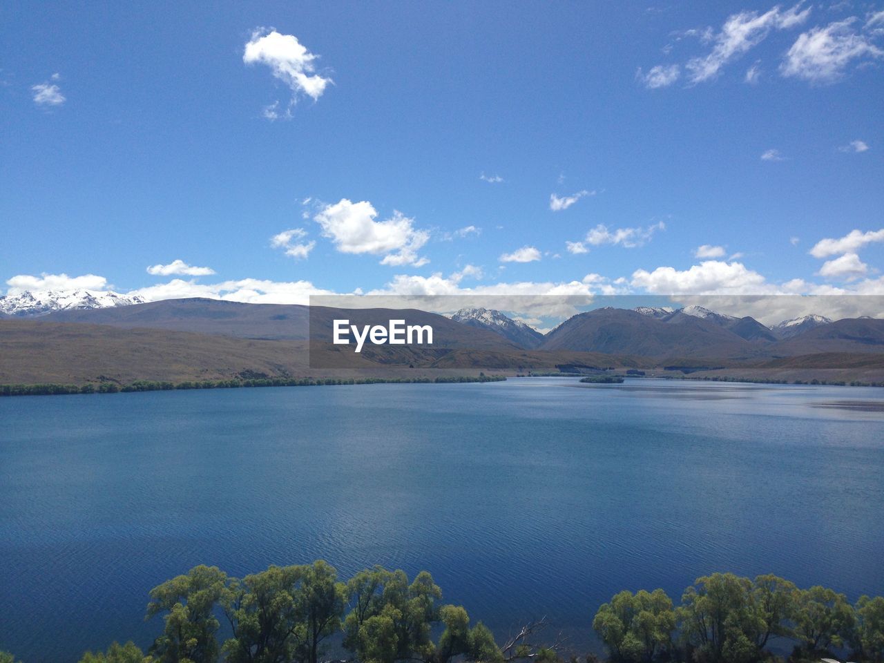 Scenic view of lake against blue sky