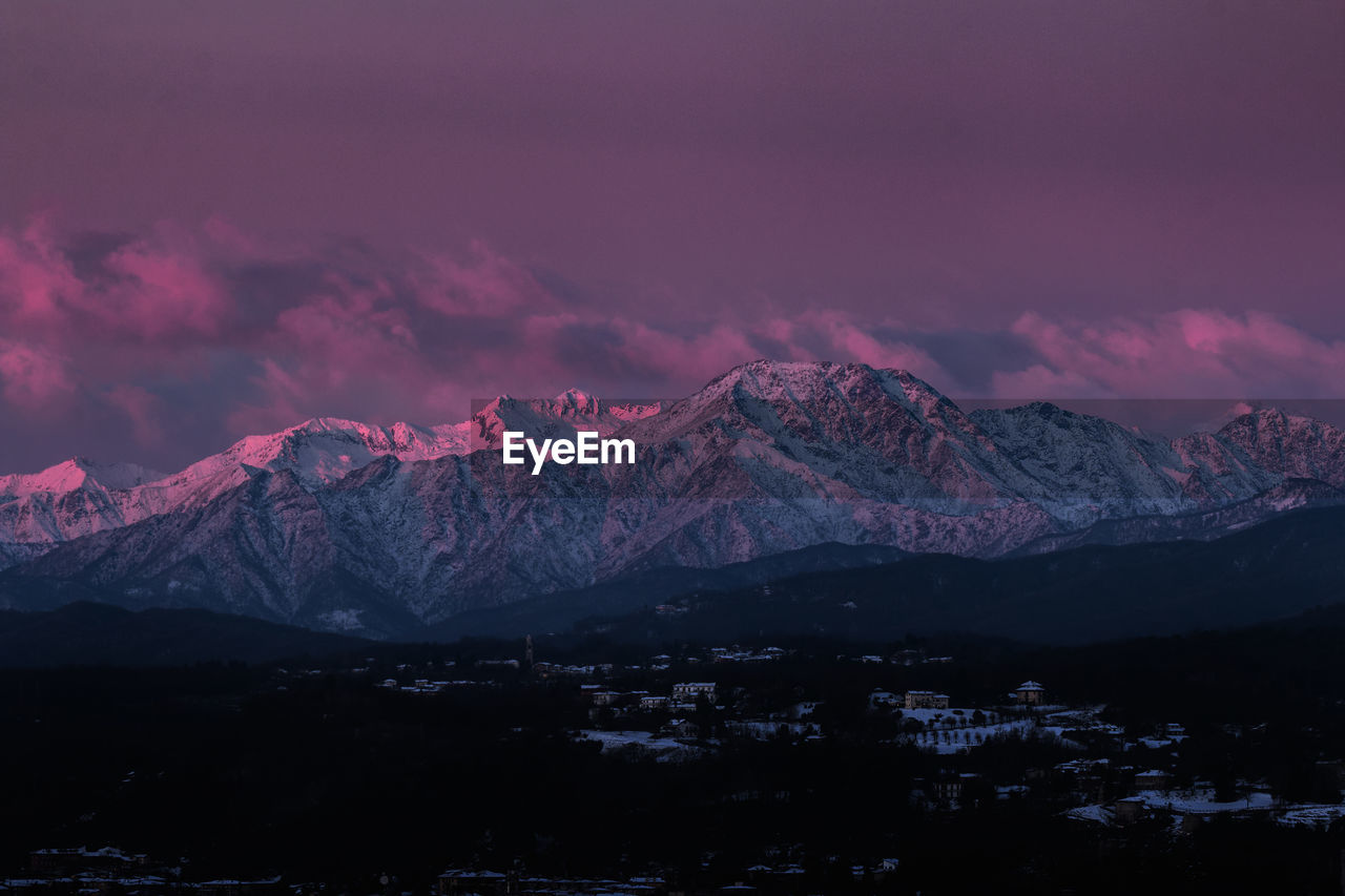 Scenic view of snowcapped mountains against sky during sunset