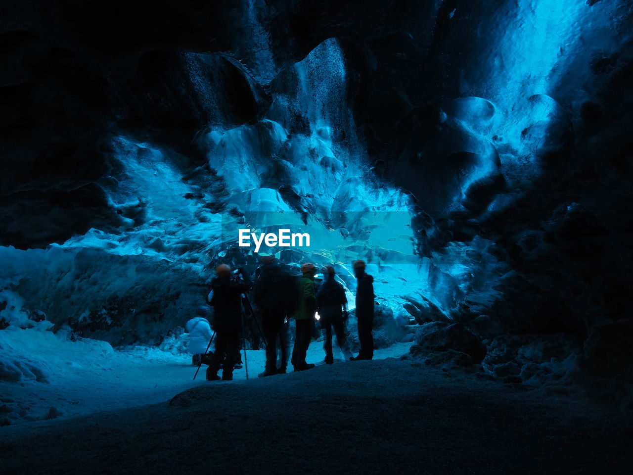 People standing in ice cave