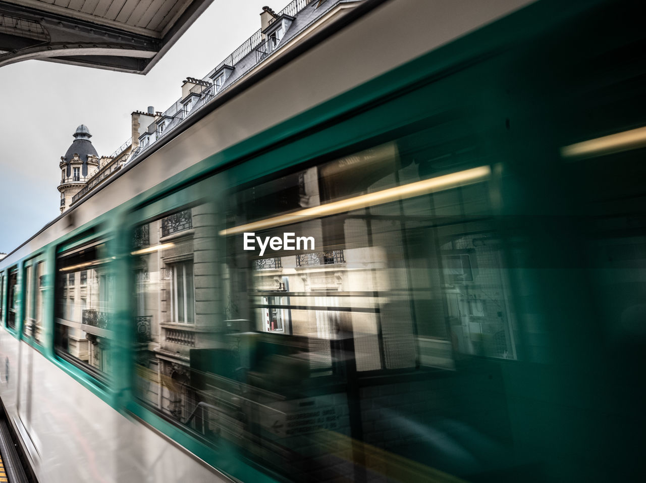 blurred motion of train at railroad station