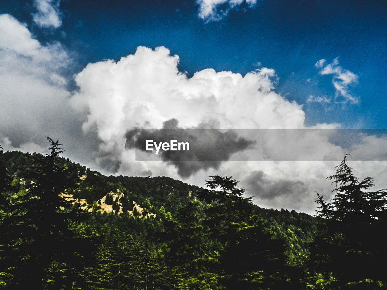 SCENIC VIEW OF MOUNTAINS AGAINST CLOUDY SKY