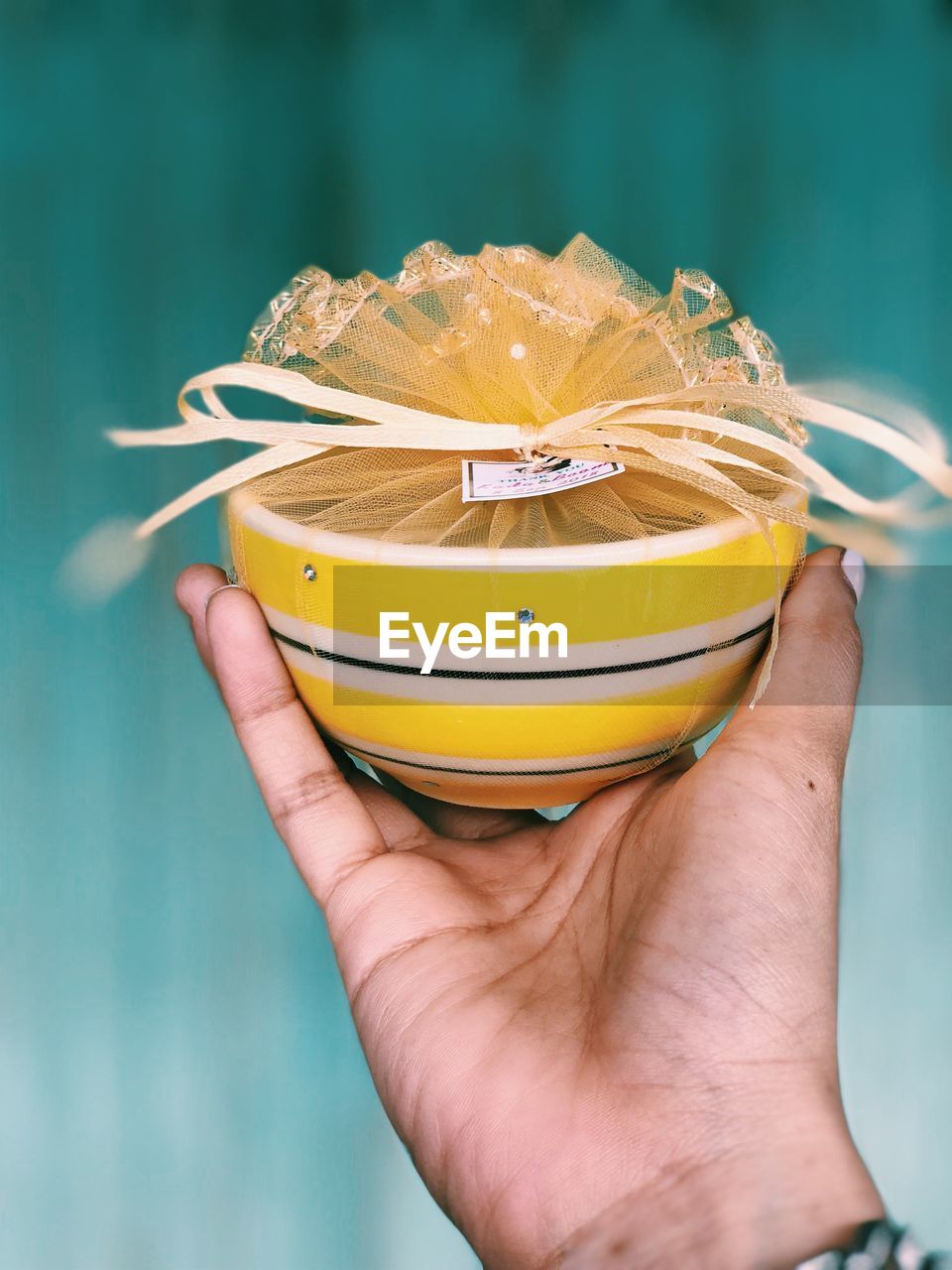 Close-up of person holding decorated bowl