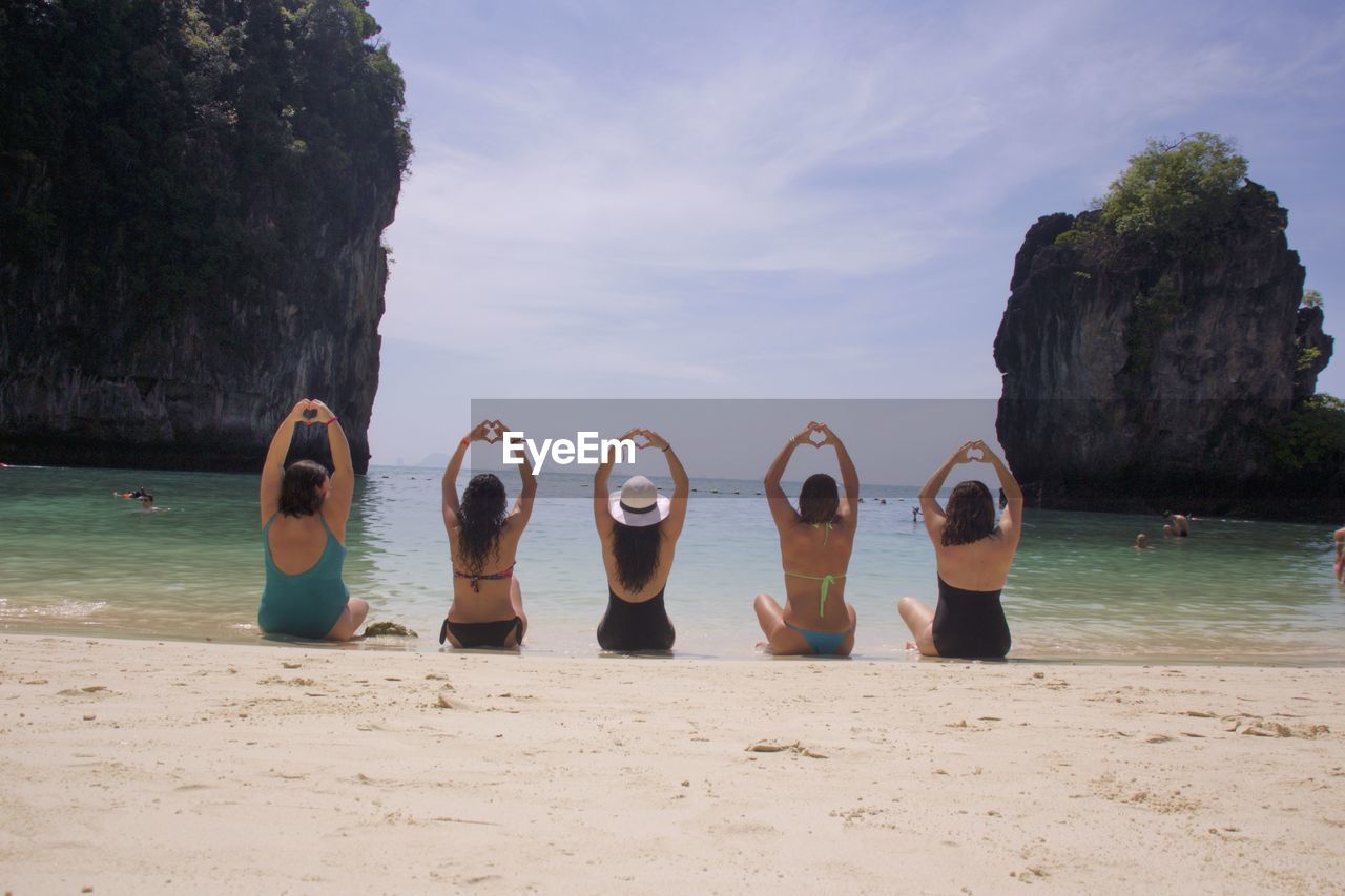 PEOPLE AT BEACH AGAINST SKY