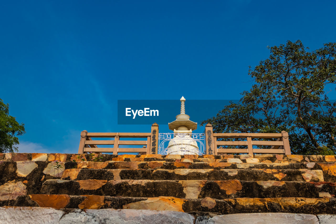 Buddhist stupa isolated with amazing blue sky from unique perspective