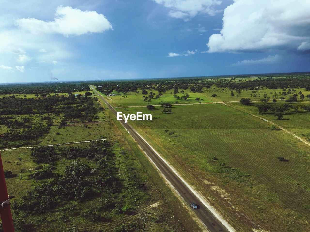 Scenic view of field against cloudy sky