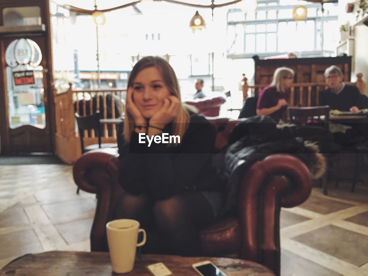 WOMAN SITTING ON RESTAURANT