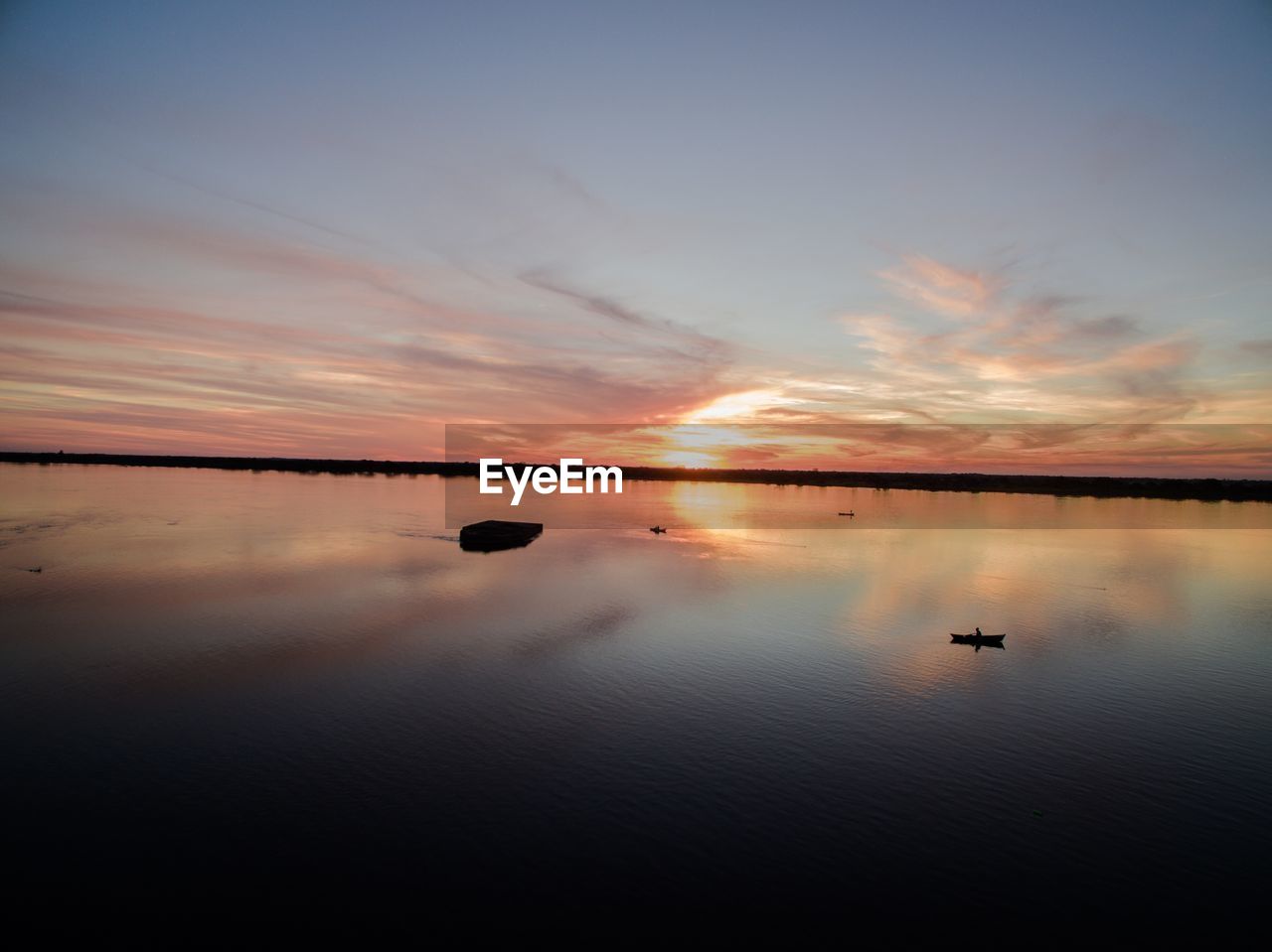 SCENIC VIEW OF SUNSET OVER LAKE