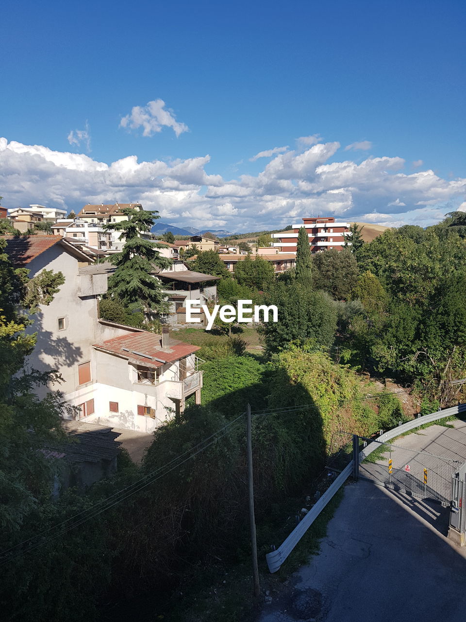 High angle view of houses in town against sky