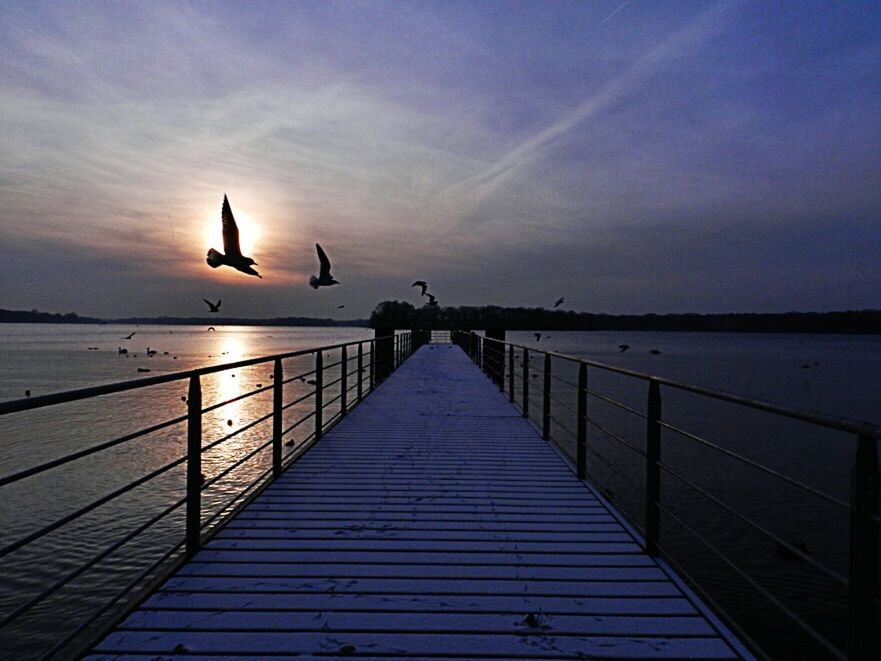 PIER ON SEA AT SUNSET