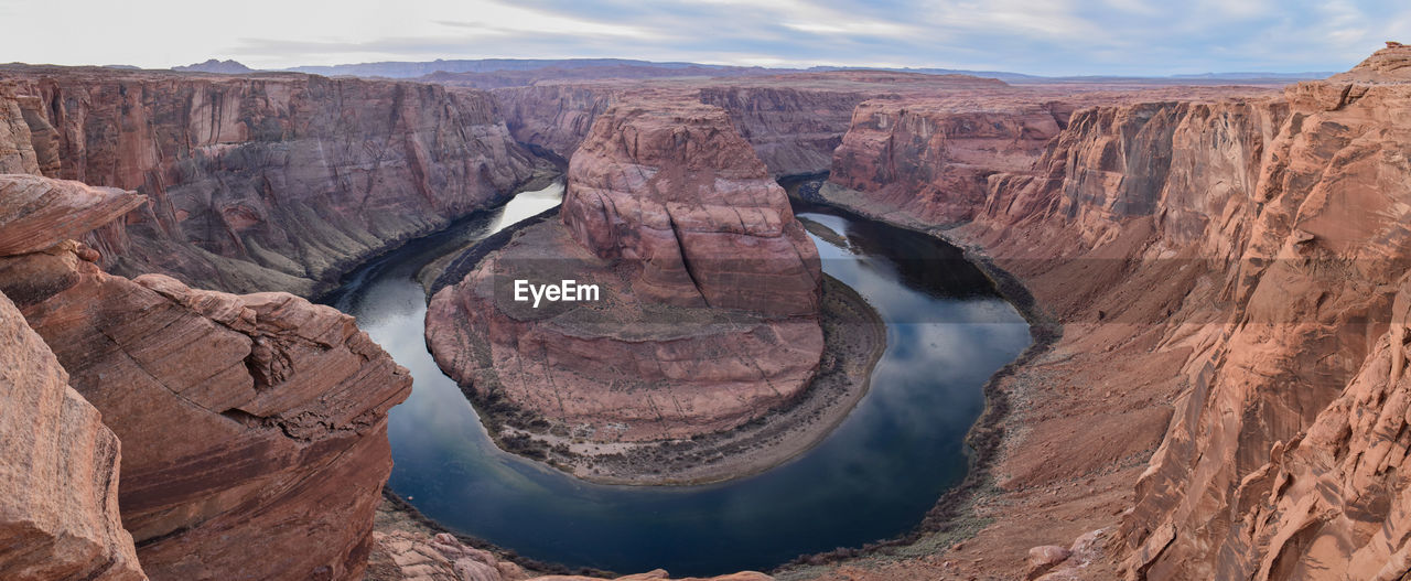 Horseshoe bend amidst mountains in desert