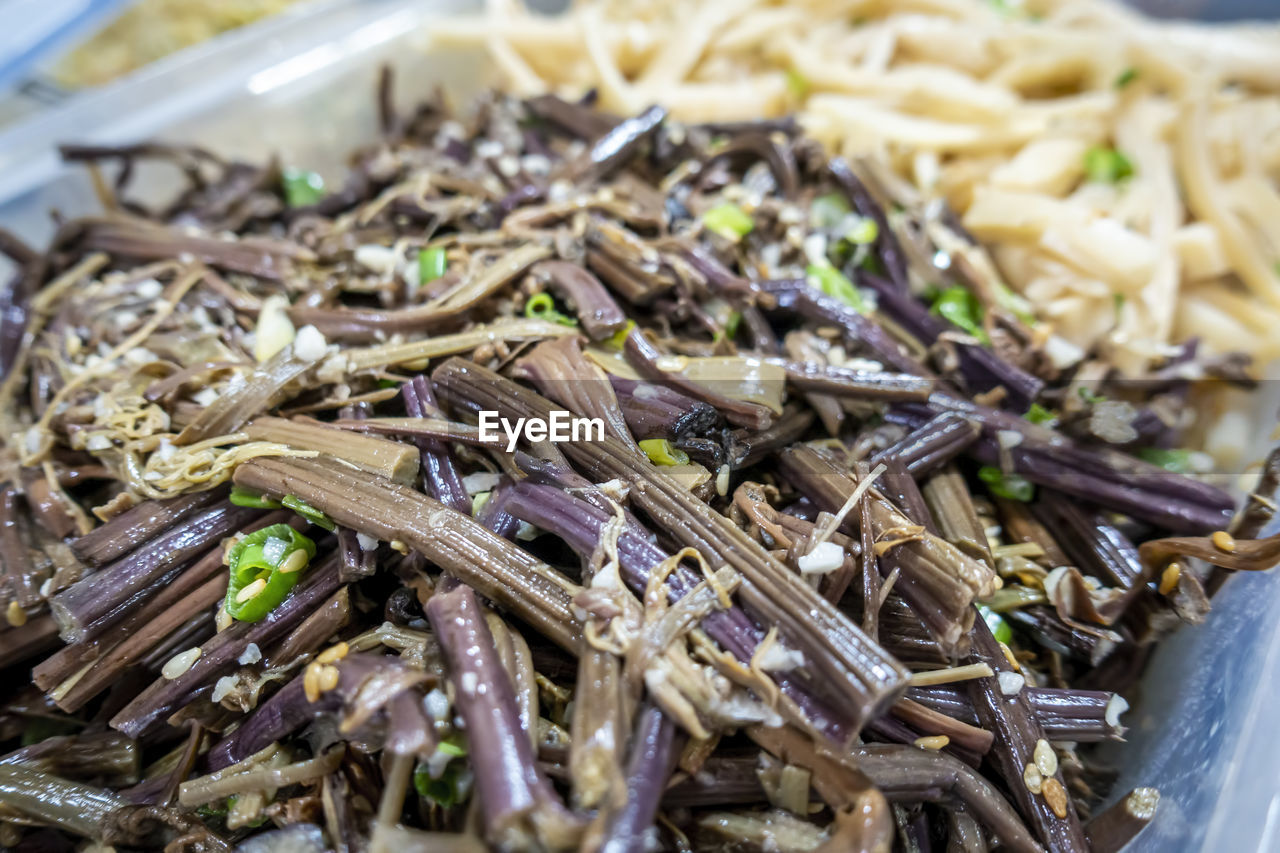 High angle view of vegetarian food on table. marinated fern frond in foreground.