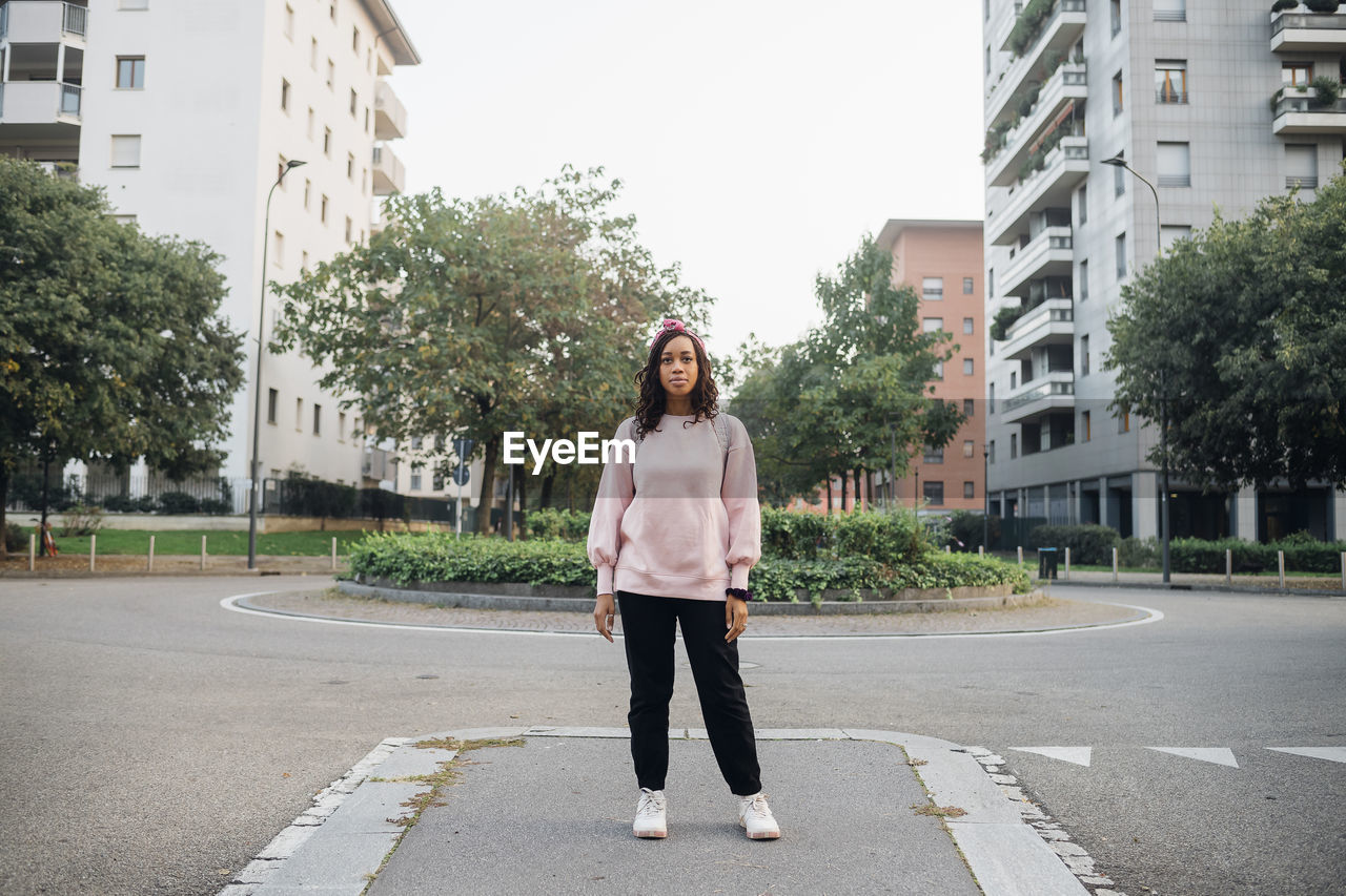 Young woman standing at city street