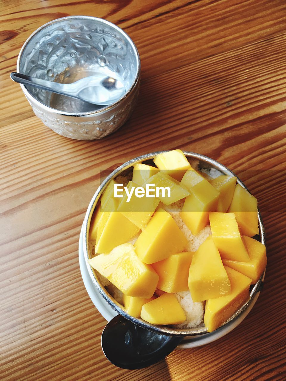 High angle view of chopped fruit on table, sticky mango rice