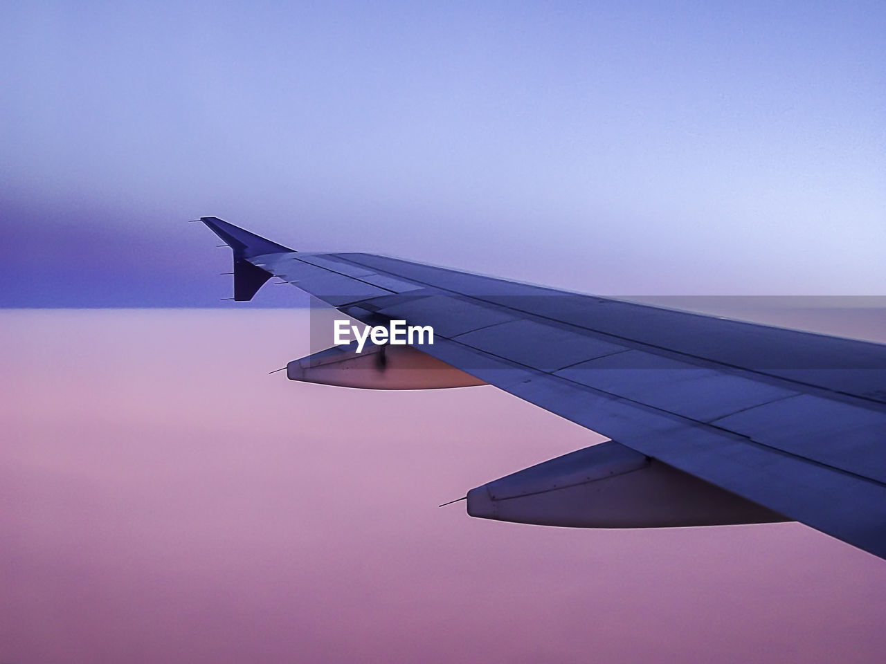 Airplane wing against sky