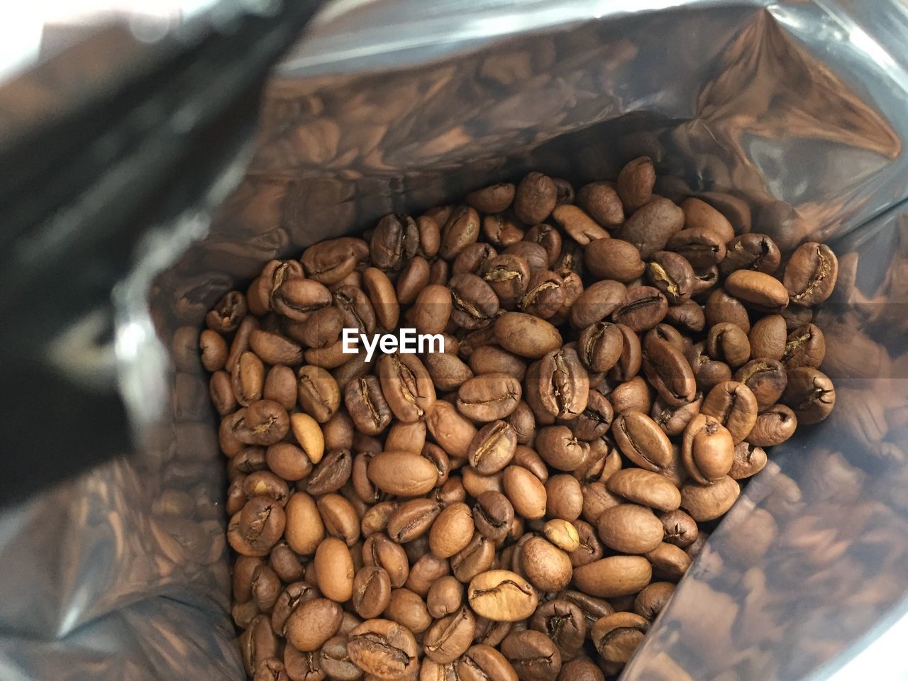 Close-up of roasted coffee beans in bag