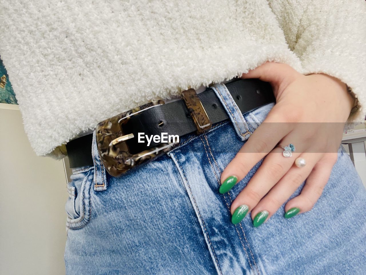 one person, hand, adult, textile, jeans, fashion, women, indoors, close-up, nail, fashion accessory, jewelry, casual clothing, blue, nail polish, ring, clothing, pattern, lifestyles, midsection, handbag, belt, denim