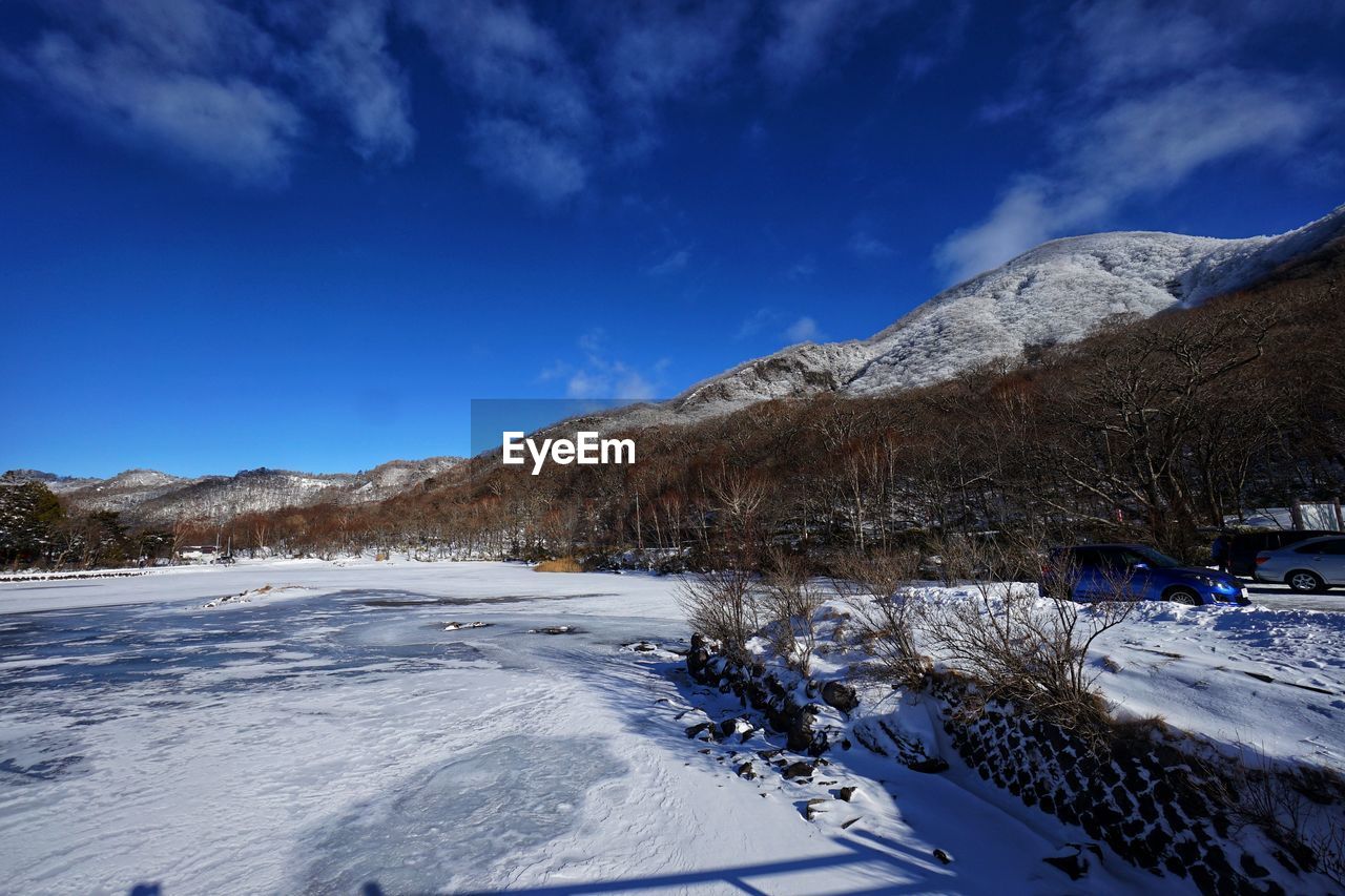 Snow covered mountain against blue sky