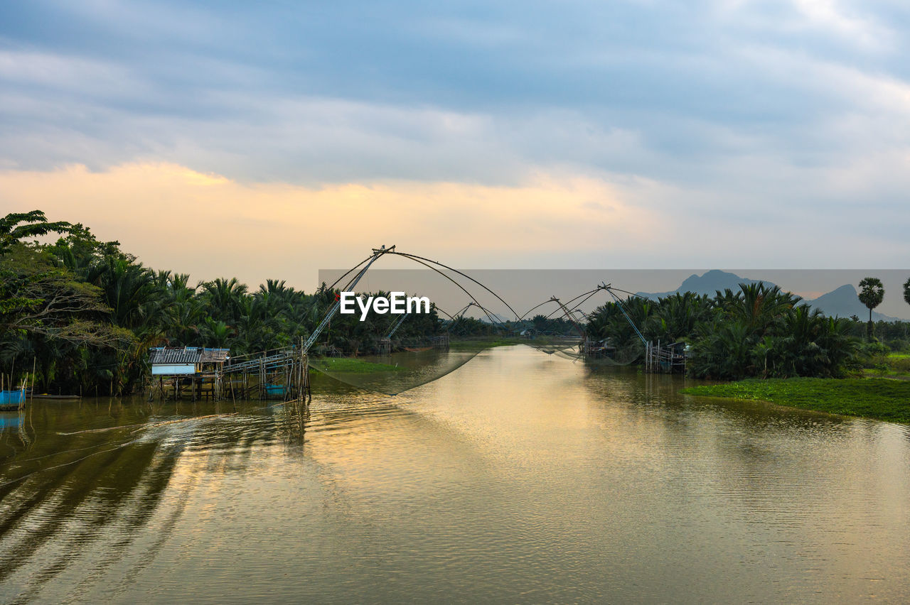 BRIDGE BY RIVER AGAINST SKY