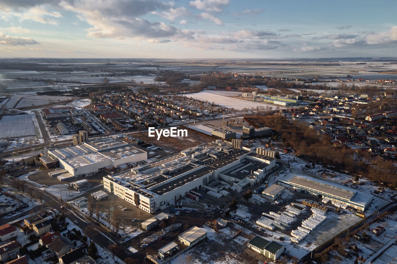 Logistic warehouse in suburban area, aerial view. industrial center with factory