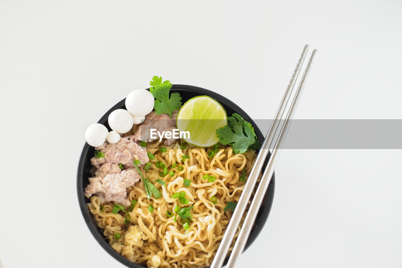 Directly above shot of meal in bowl against white background