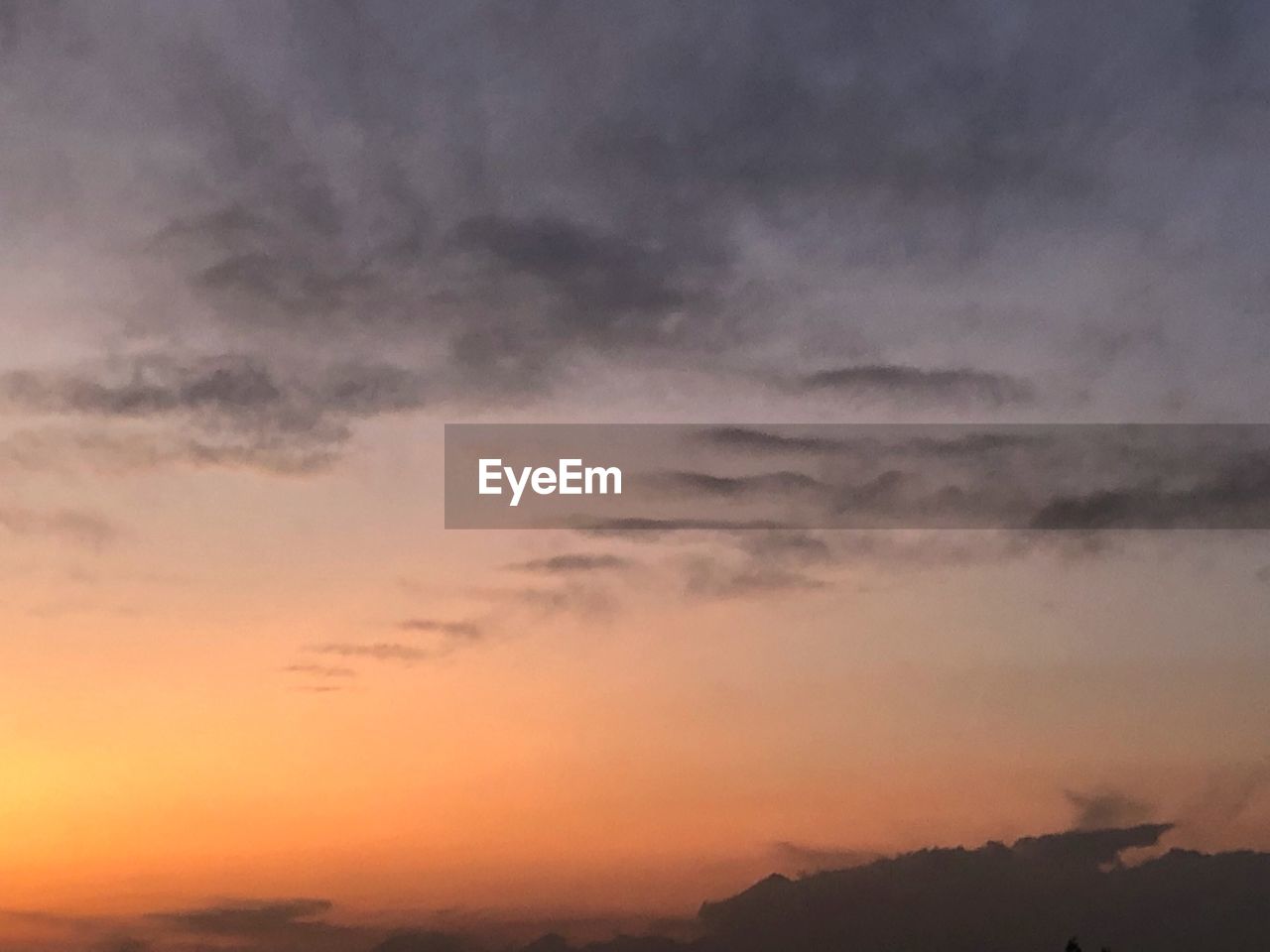 LOW ANGLE VIEW OF CLOUDY SKY AT SUNSET