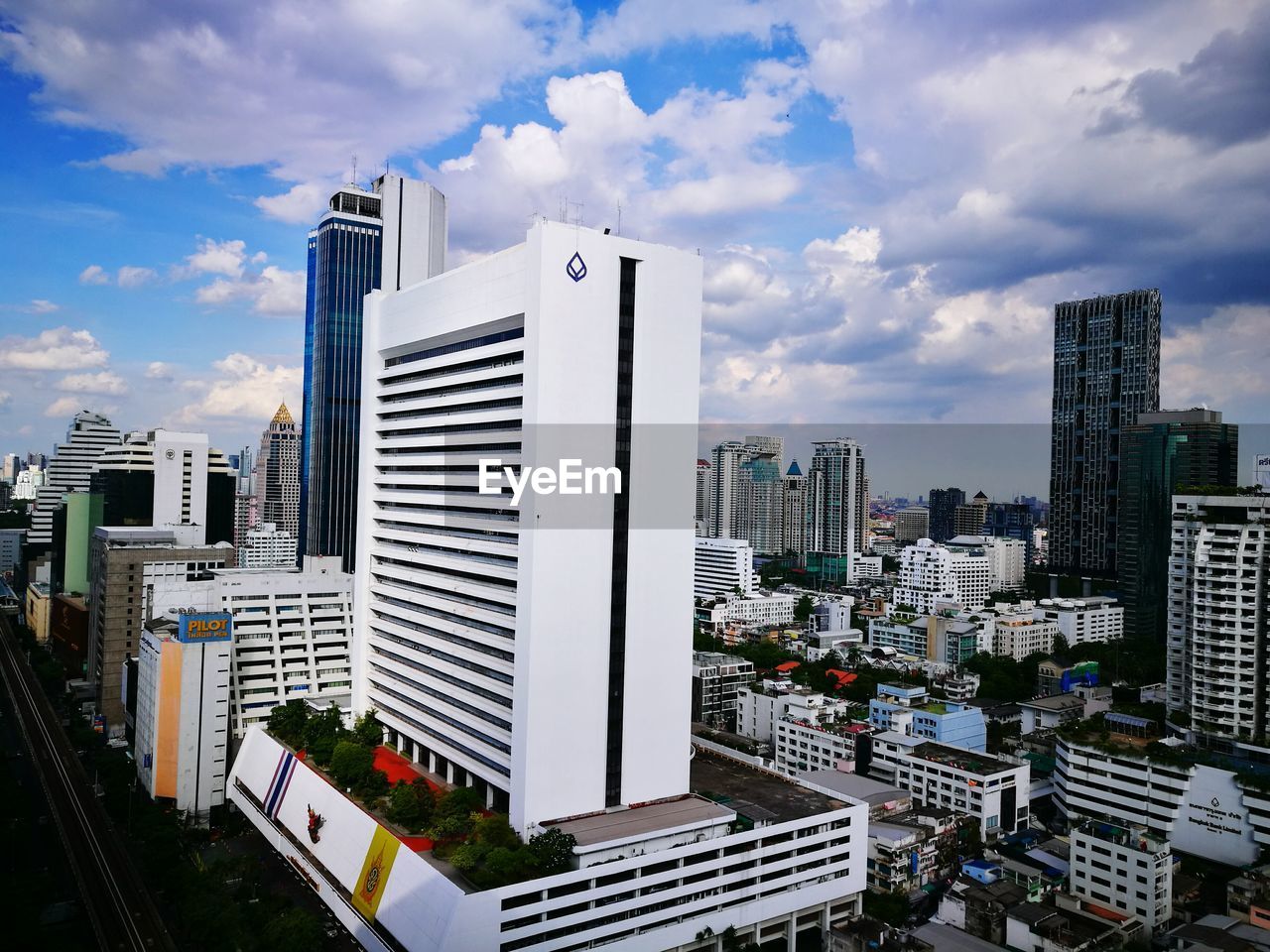 Buildings in city against cloudy sky