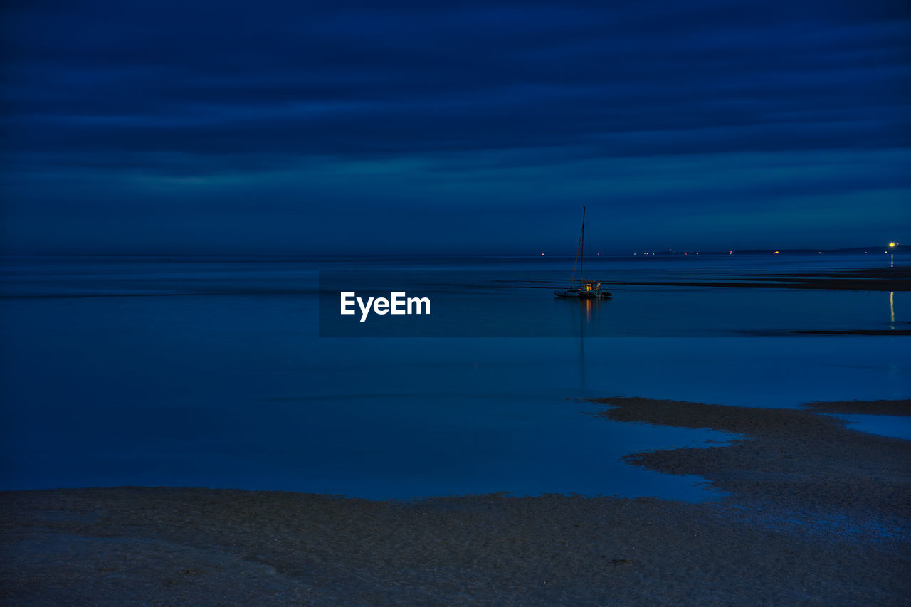 Scenic view of sea against sky at dusk