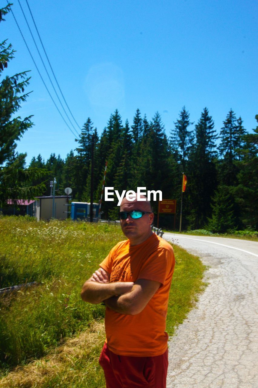 MAN STANDING AGAINST CLEAR SKY