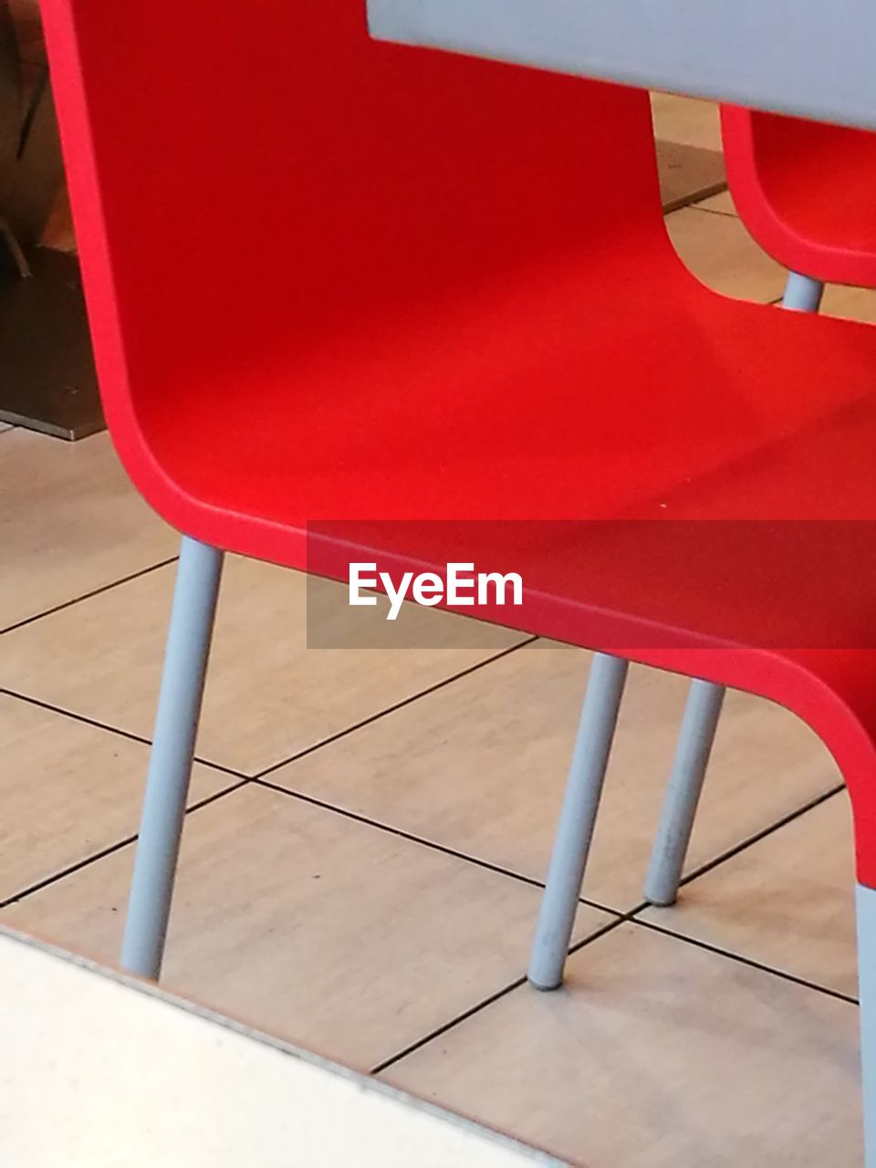 HIGH ANGLE VIEW OF EMPTY CHAIR AGAINST BLUE SKY