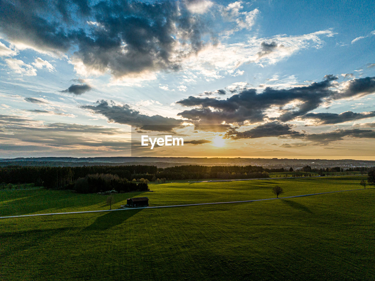 Scenic view of field against sky during sunset