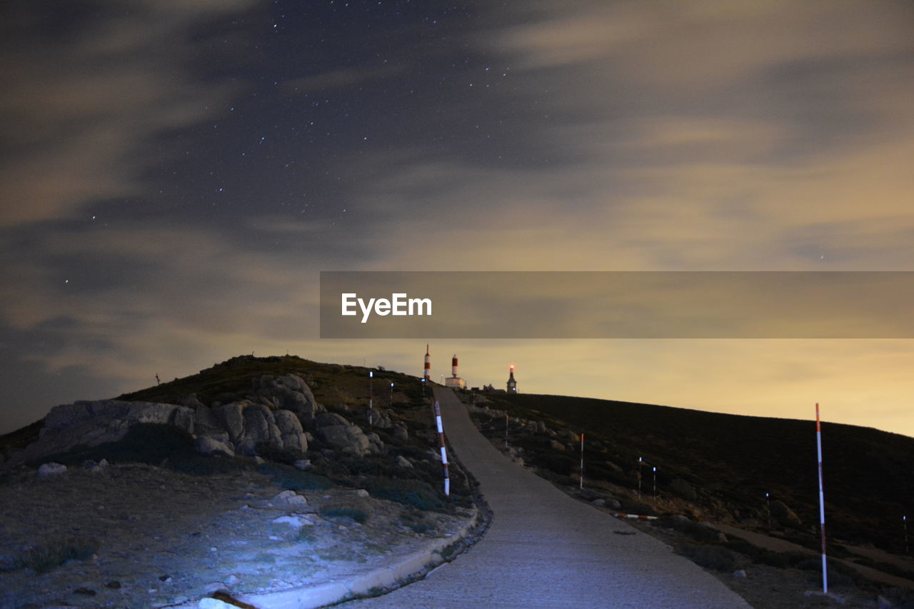 SCENIC VIEW OF ROAD AGAINST SKY AT SUNSET