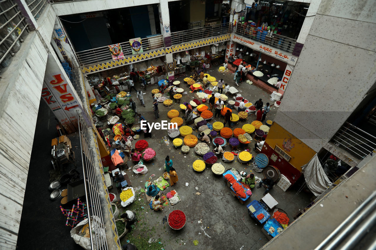 high angle view, architecture, crowd, group of people, city, transportation, large group of people, built structure, lego, street, mode of transportation, building exterior, directly above, city life, day, outdoors, city street