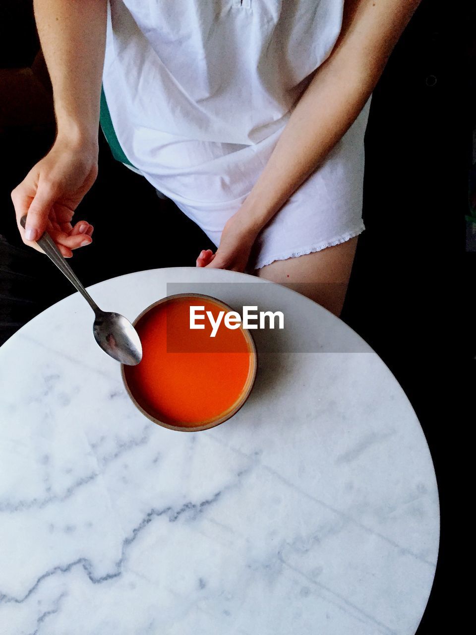High angle view of woman eating soup
