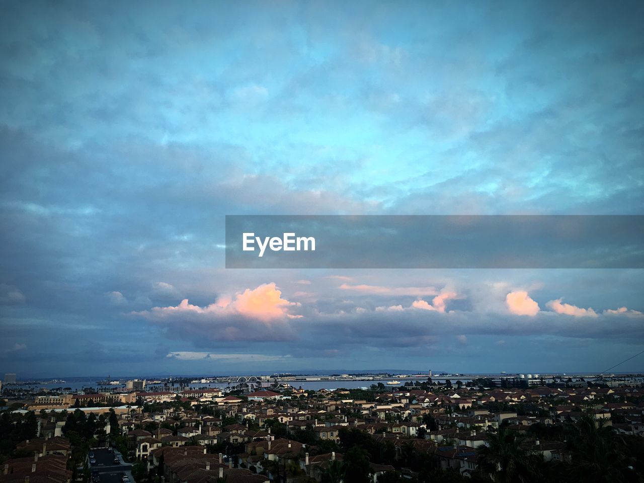 High angle shot of townscape against clouds