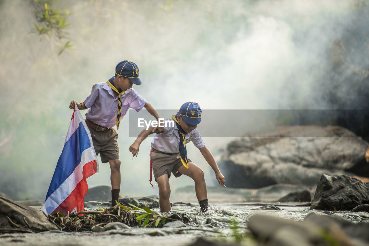 BOY WITH UMBRELLA ON SHORE