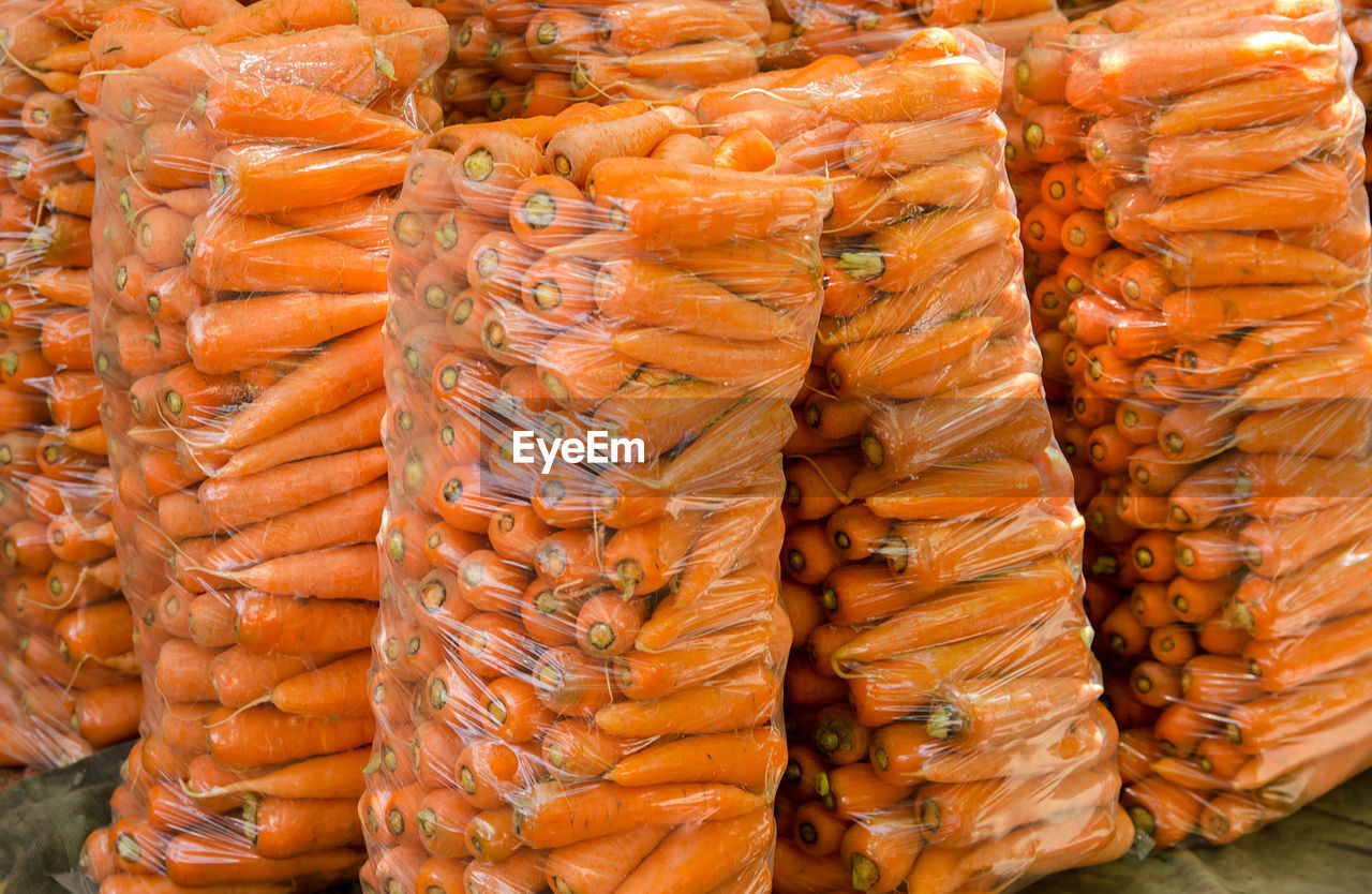 Bags with young fresh carrot prepared for sale. freshly harvested carrots.